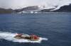 BRAVE NEW WORLD: Australian explorers and scientists have played a key role in shaping what we know about Antarctica. Pictured: A light amphibious resupply cargo vessel transporting gear in February 2004 with Stephenson Glacier in the background, Heard Island, Antarctica. Photo: D.E. Thost courtesy of National Library of Australia. 