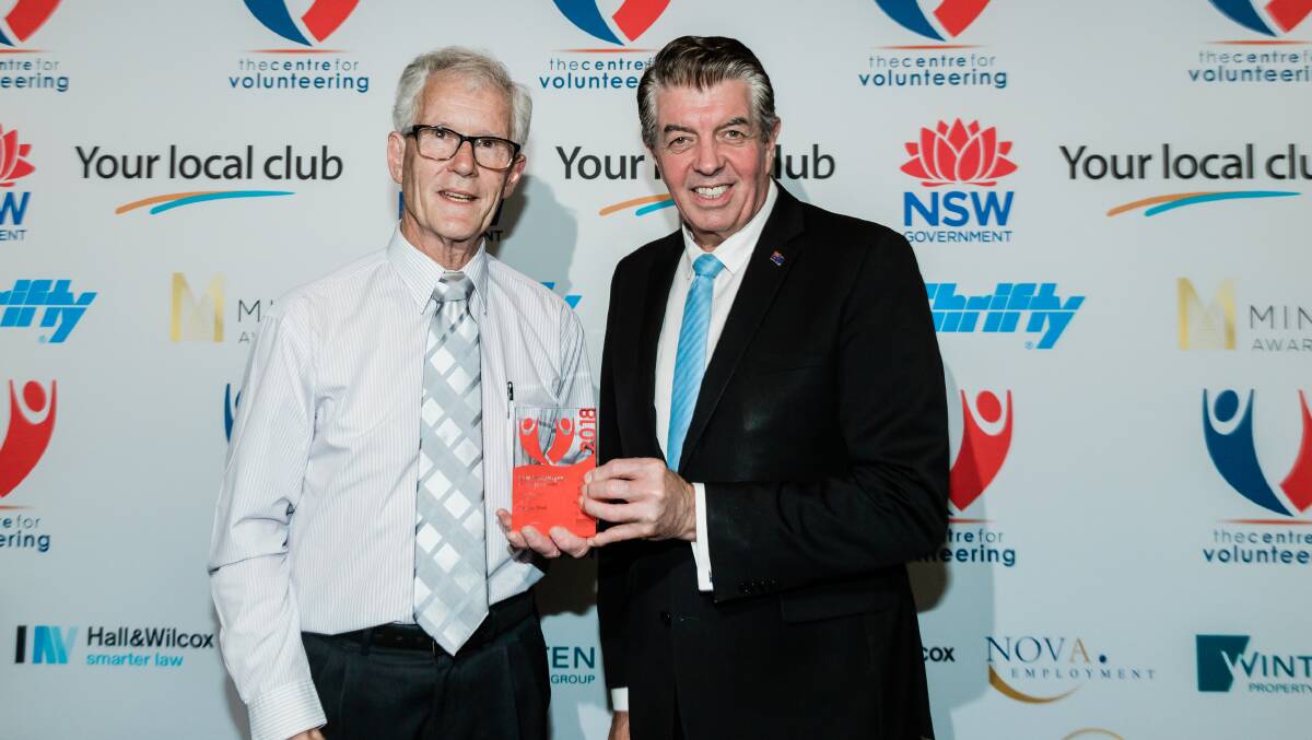 CHIPPING AWAY: NSW Senior Volunteer of the Year George Tillett is using his experience with computers to help improve the lives of people with disability. Pictured with volunteering minister Ray Williams.