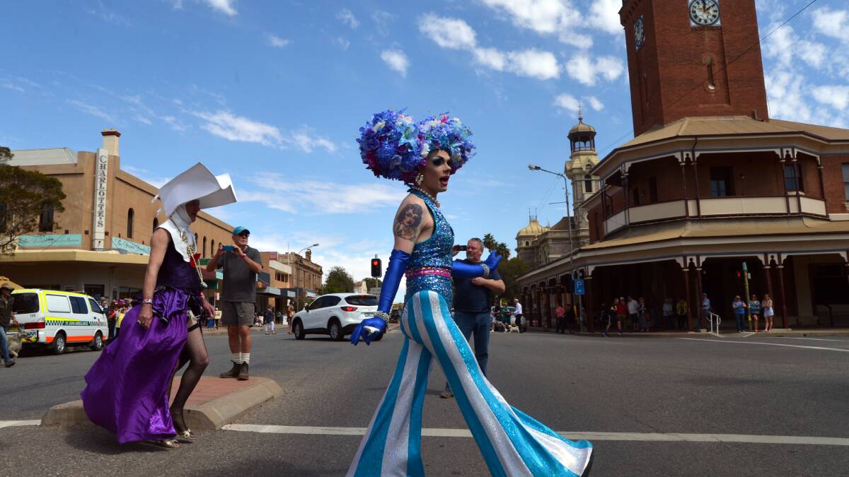 STREET ART: Art Simone will co-host this year's Broken Heel Festival. The colourful co-host is pictured leading drag queens across Argent St.. 