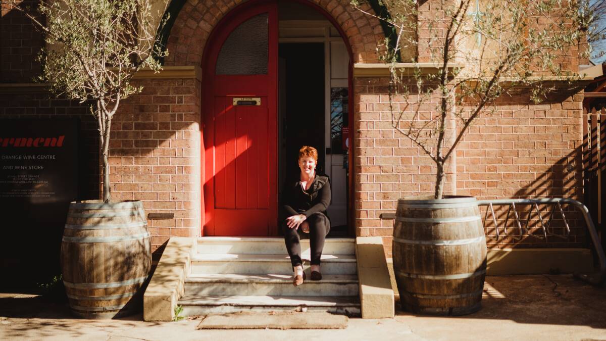 WINE O'CLOCK: Nicole Farrell sitting on step at Ferment wine bar, just one of the many food and wine destinations to explore in Orange. Photo: Joanna Pascoe