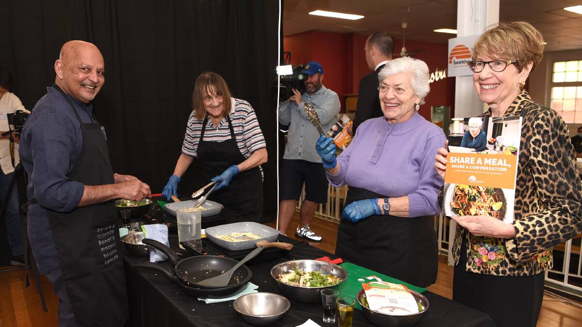 FOOD IS LOVE: A new cookbook which can be downloaded online is encouraging people to connect over food and technology. Pictured: Kumar Pereira (left) and Margaret Beazley (right) with Beehive Industries support users at the cookbook's launch event.