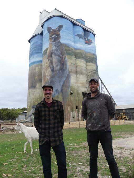 Large-scale mural artist Cameron Scale and his assistant Andy Davis with the finished the Kingscote silo art project on Kangaroo Island. Photo: Stan Gorton 