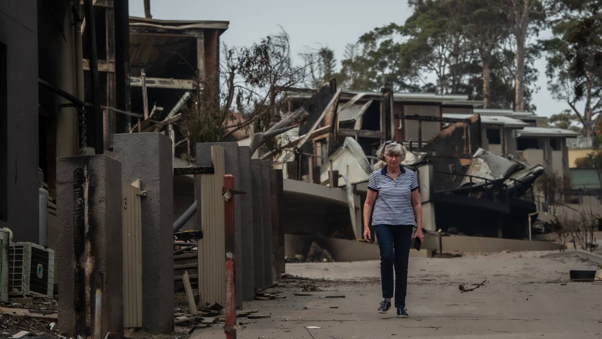 Susan Magnay returns on New Year's Day to take stock of what she and husband Philip Bell lost at Malua Bay the previous day. Photo: Karleen Minney.
