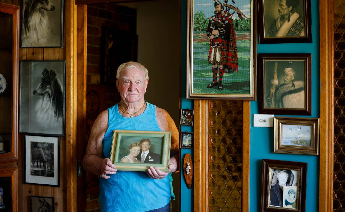 John Edmond is pictured holding a framed photo of himself and Susan at his Farmborough Heights home on February 1, 2024. Picture: Anna Warr