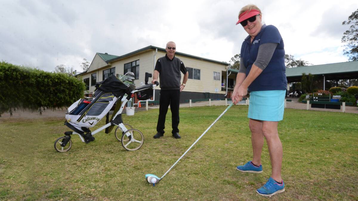 Postiive swing: Wingham Golf Club secretary manager Gary Considine and Lesley Steel. The club will soon become a Lifestyle Living Community. Photo Scott Calvin