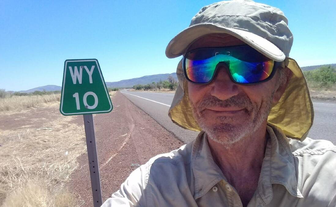 HIGH ROAD: Dominique Fischer takes a pitstop and a selfie on the long road during his trek.