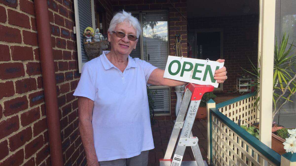 TREASURED MEMORIES: Volunteer of the Year People's Choice nominee Ruth Anderson with two mementos - a ladder and open sign - from the Nulsen Op Shop which she ran for 50 years before it closed. 
