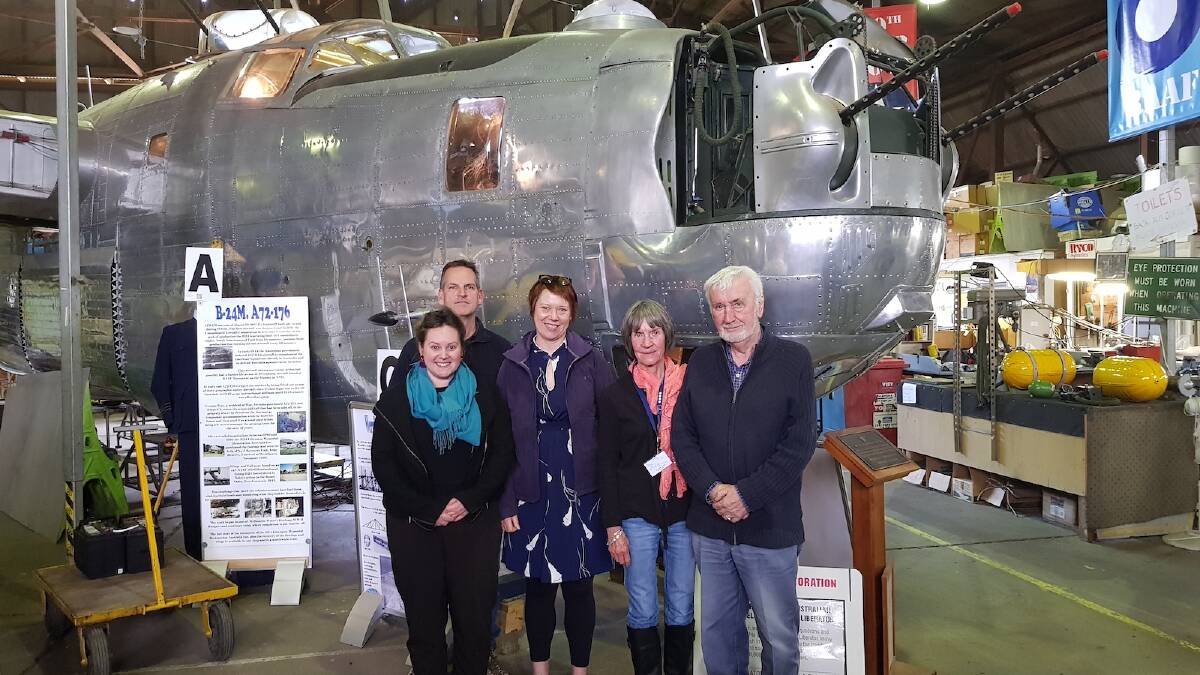 Reach for the sky: The magnificent B-24 Liberator, a restoration work-in-progress, and the star attraction in a newly accredited museum in Werribee. Pictured from left – Amelia Marra (Museums Australia), Ken Abbott vice-president Liberator Memorial, Simone Ewenson (Museums Australia), Lyn Gorman, Dave Miller.  