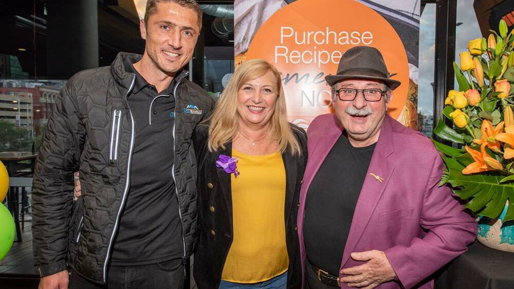 Perth Glory player Dino Djulbic, Community Vision CEO Michelle Jenkins and butcher Vince Garreffa at the launch of the Recipes to Remember celebrity cookbook.