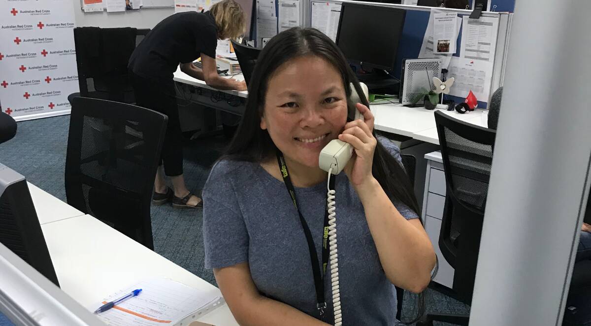 Gold Coast volunteer Chiung-Wen (Monita) Lin brightenes the day of an elderly Queenslander with a weekly "Ni Hao" social phone call.