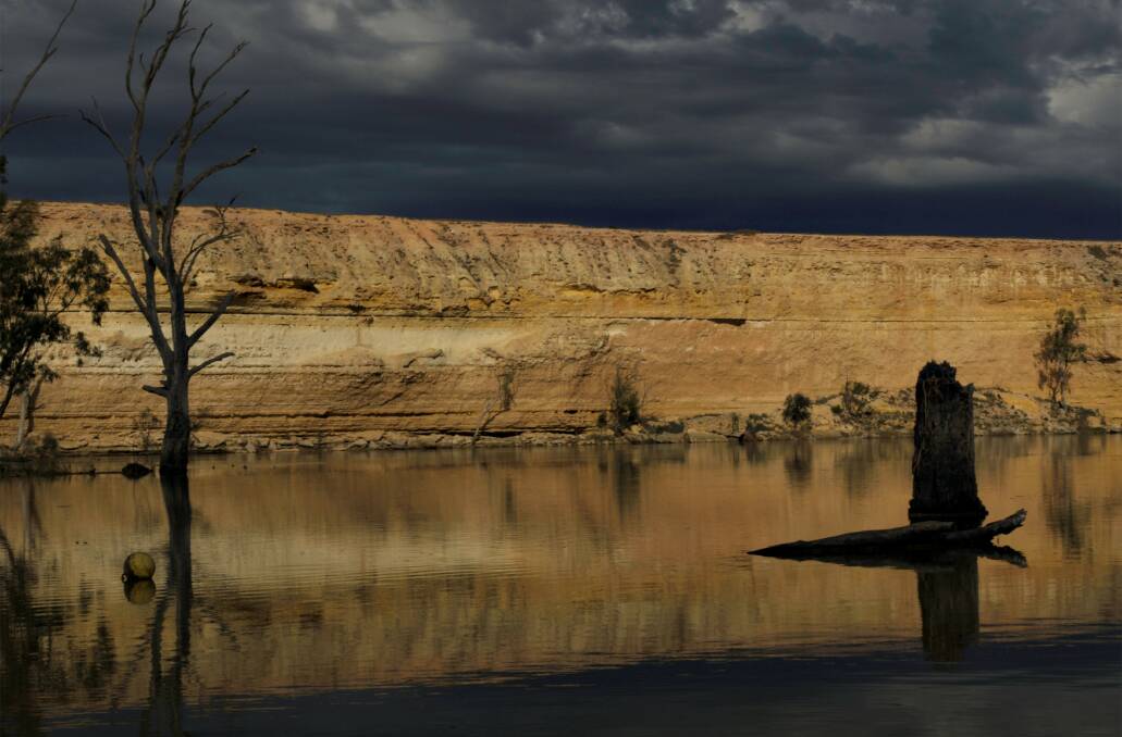 RIVER REFLECTIONS: A photograph from the exhibition shows cliffs and a storm brewing near Blanchetown.