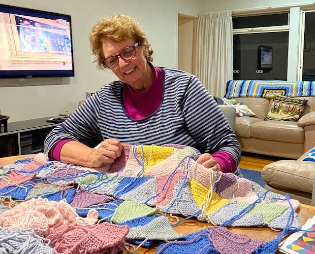 
NOT QUITE CUTTING A RUG: Sue Conwell with the blanket she's trying to finish off after starting it two years ago. 