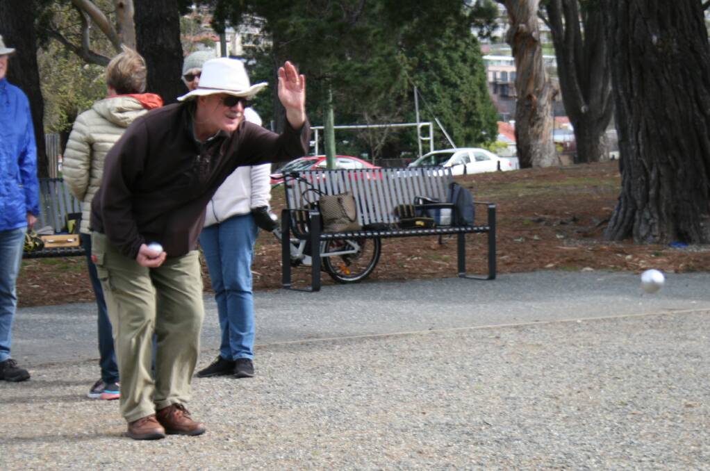 IN FULL FLIGHT: Hobart Petanque Club's Stuart Commin shows how it's done. Petanque is a sport played all over the world; newcomers are always welcome.