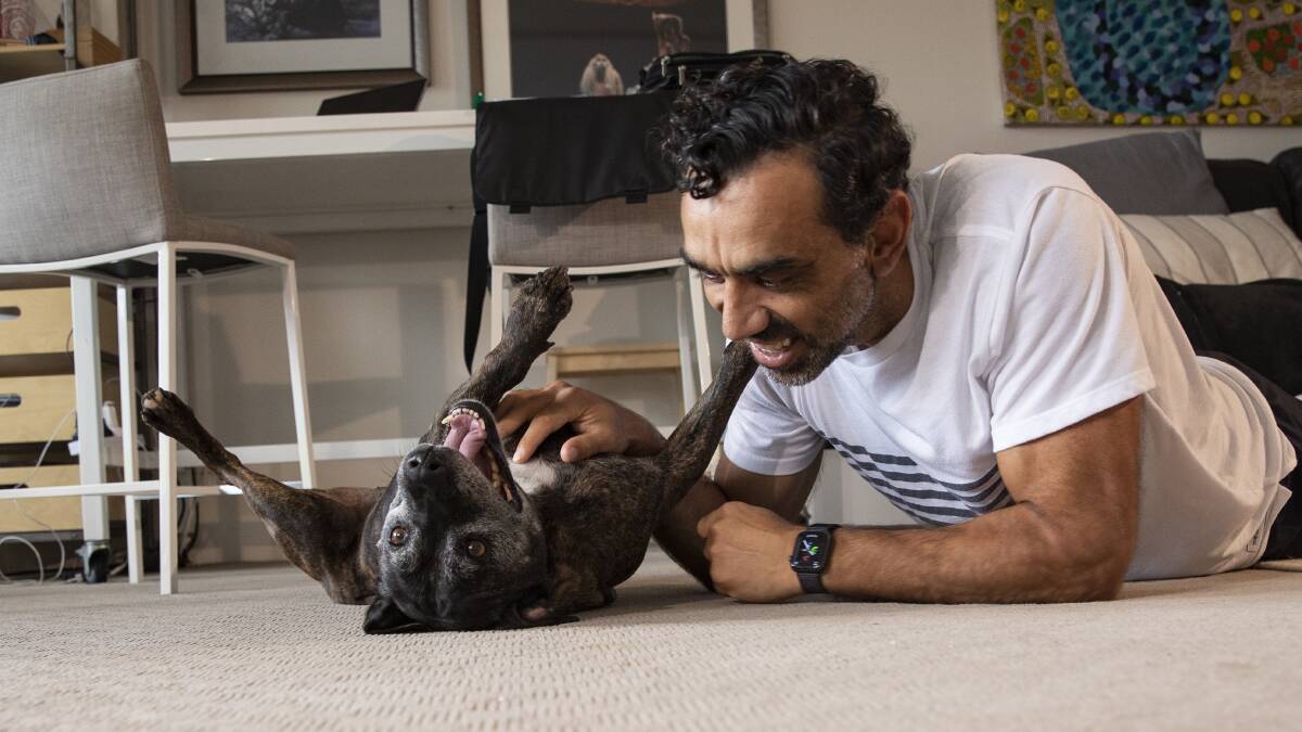 DOMESTIC BLISS: Senior Pets Project ambassador Adam Goodes with Chance, who has found a loving home with his family.