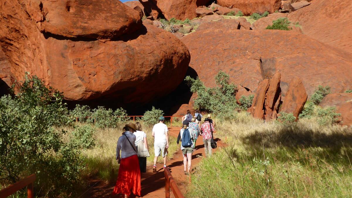 ANOTHER APPROACH: A walk around the base of Uluru is seen as a more culturally appropriate way to admire the landmark.