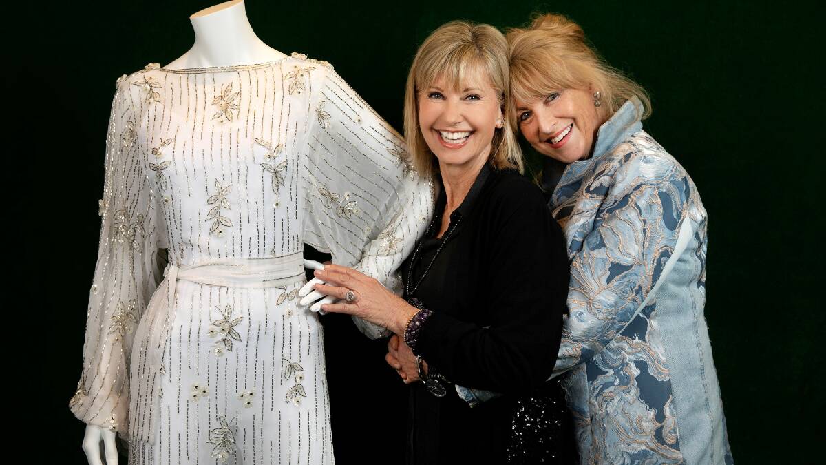 STYLE STATEMENT: Olivia Newton-John and Fleur Thiemeyer with one of the fabulous gowns now included in the Australian Performing Arts Collection. Photo Nicole Cleary