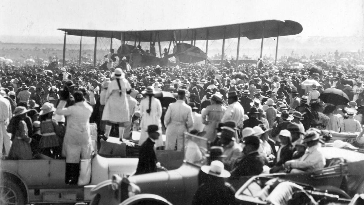 HEROES' WELCOME: A crowd greets the arrival of the Smith brothers in their Vickers Vimy at Northfield after their historic flight from England.