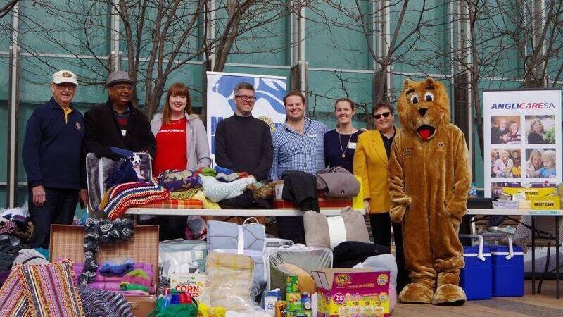 BRINGING COMPFORT: Members of the Mawson Lakes branch of Lions with donated goods they have collected. 