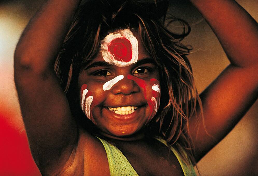 LITTLE BIG FAN: Lajamanu girl Carol Green Napangardi has her face painted with her local footy teams colours as she cheers them on at Lajamanu in the Northern Territory. Photo: Bill Bachman