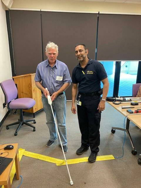 CONSTANT INNOVATION: Bashir and a client try out the WeWalk Smartcane
on White Cane Day.