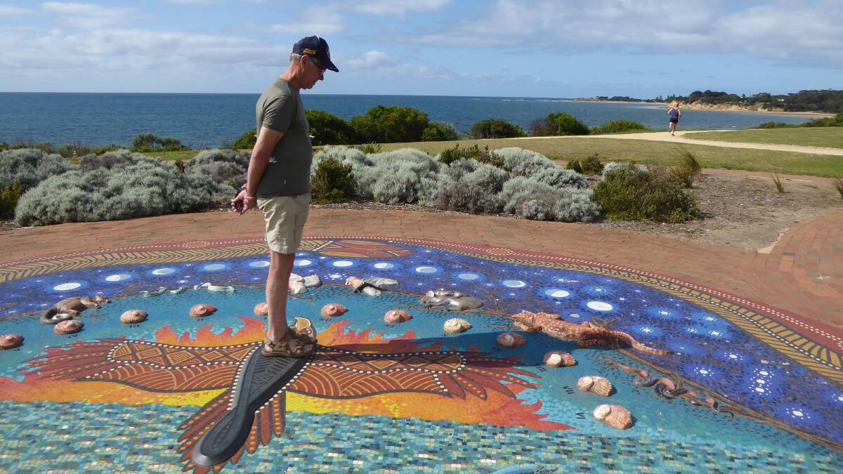 TIME ON HIS HANDS: A visitor stands in the central analemma of the Sundial of Human Involvement. His shadow indicates the hour of day.
