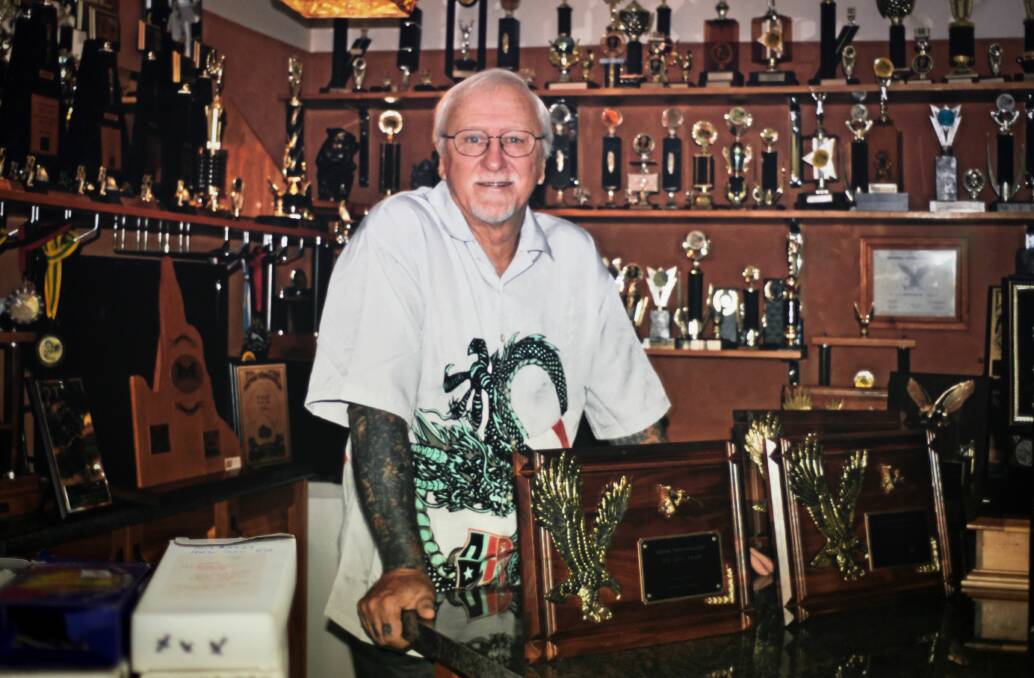 ONE OF THE BEST: Les Bowen, pictured in his trophy room, is one of Australia's most awarded tattoo artists.