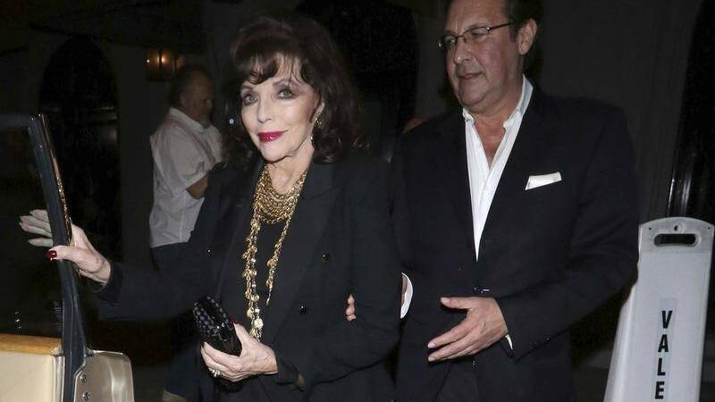 SURVIVOR: Joan Collins and her husband Percy Gibson in 2019 after escaping a blaze that broke out inside their home. 