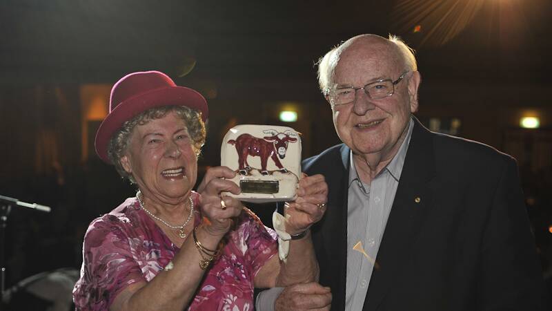KEEP ON SMILING: Marcelle Levi presents Father Bob Maguire with a Crimson Dog award at the Crimson Dog Cabaret Club produced by her son Jack.
