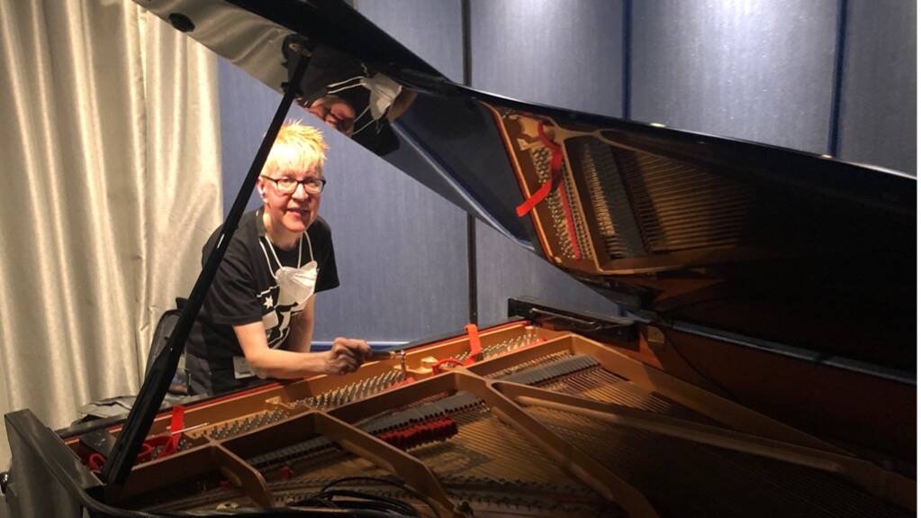 IN TUNE: Carol Johns tunes a piano on a ship. 