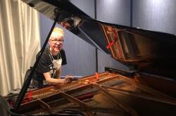 IN TUNE: Carol Johns tunes a piano on a ship. 