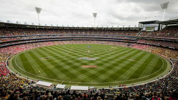 ONE FOR THE ROUND FILE: For some, a day at the footy is a day better spent. 