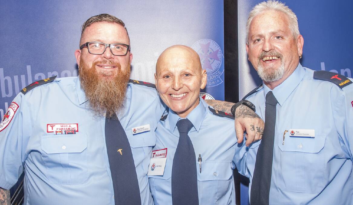 DETERMINED: A proud, defiantly bald Deb Rielly celebrated 25 years in the ambulance service with colleagues Paul Dodd and Tim Jobling.