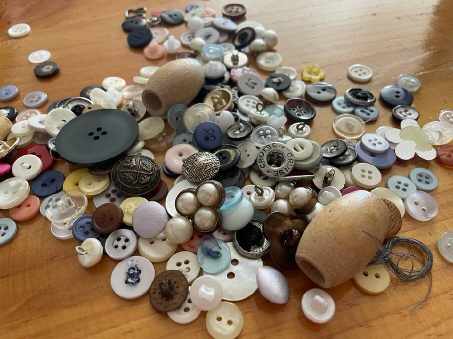 Buttons of various shapes, sizes, styles and colours scattered on a table. File picture