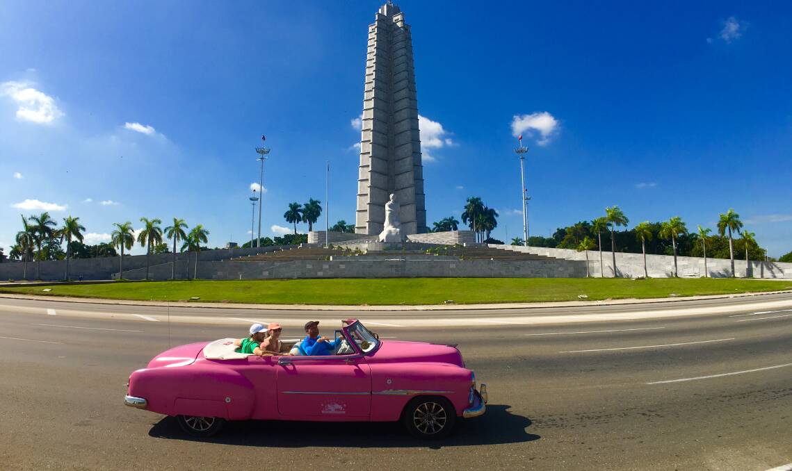THE ONLY WAY TO TRAVEL: A Chevrolet speeds past Revolution Square in Havana.