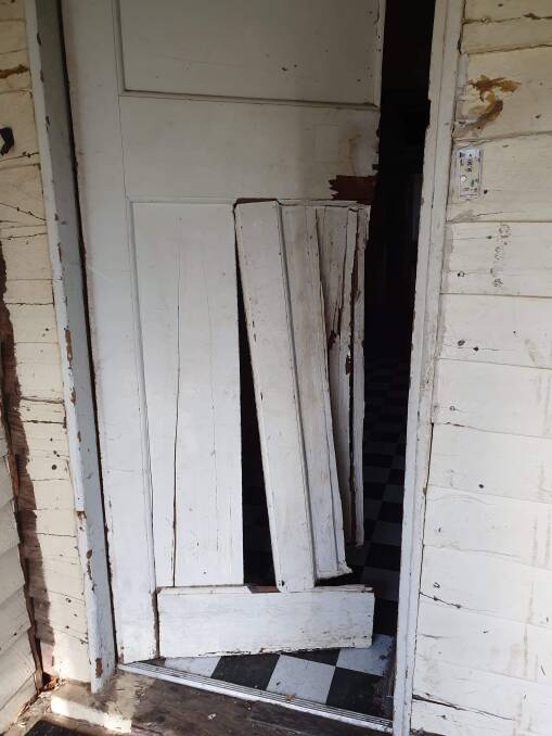 DESTROYED: The front door of the house is unable to be locked after being damaged by the squatter.