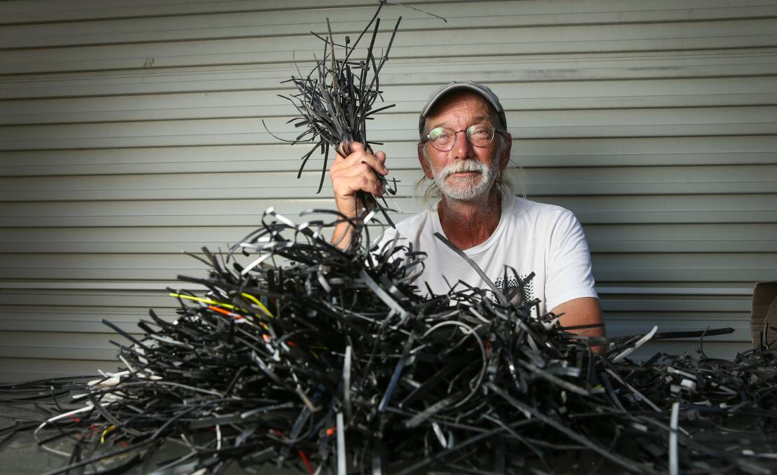 Rusty Cherkas with the cable ties he has collected around Newcastle's CBD since May. Picture: Marina Neil