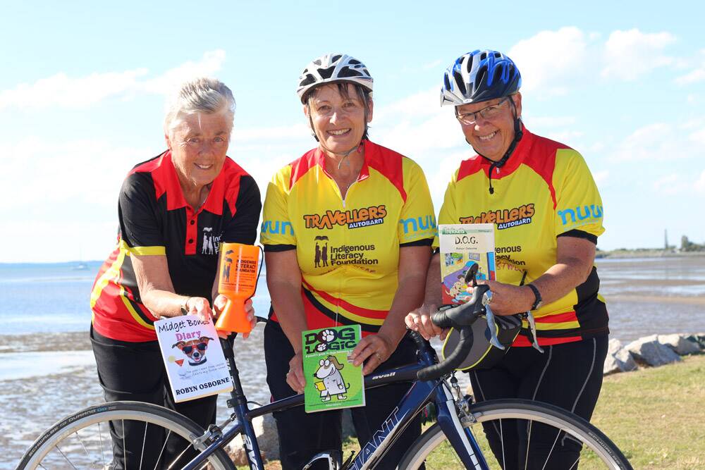 Road supporter Pat Williams, 74, with two of the Queensland riders crossing the red centre for Indigenous literacy, Annie Samain-Bright and Brenda Noonan.