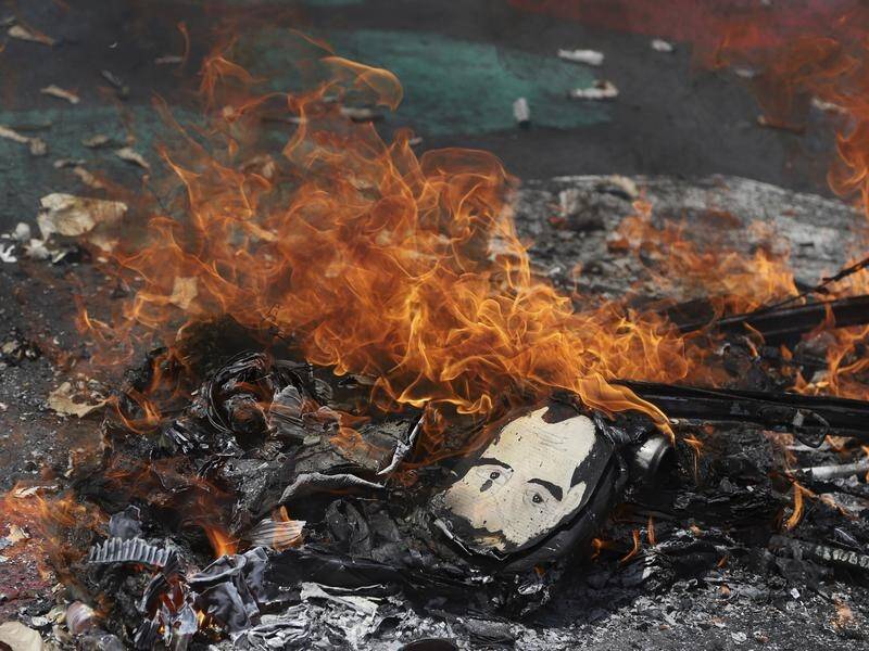A burning effigy of El Salvador's president during the anti-government protest.