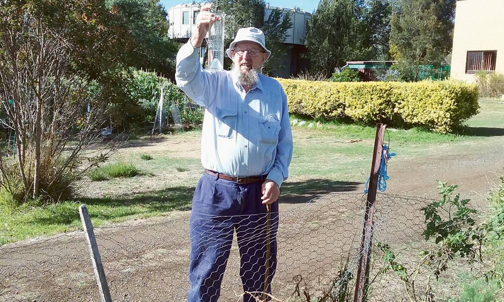 WELL-WEATHERED – Peter Jones checks the rain gauge at his home near Orford.