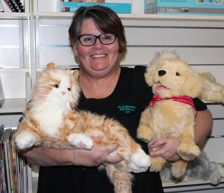 CREATURE  COMFORTS – Alzheimer's Australia South Australia's resource centre manager Sue Severino with a robotic cat and puppy.