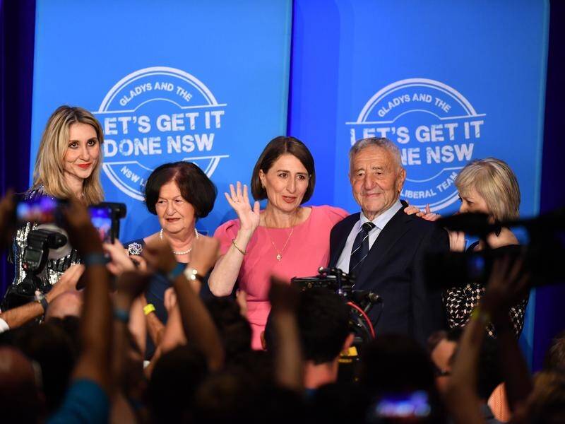 NSW Liberal leader Gladys Berejiklian celebrates her election win with her family.