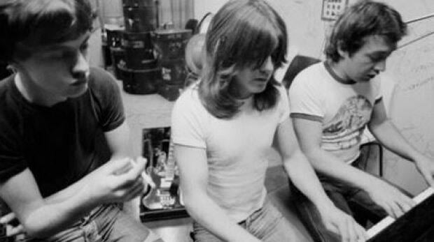 AC/DC producer George Young (far right) with brothers Malcolm and Angus Young. Photo: Facebook / AC/DC