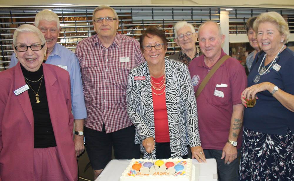 BUSY TIME – Association of Residents of Queensland Retirement Villages president Judy Mayfield (centre) cuts the organisation’s 25th anniversary cake.