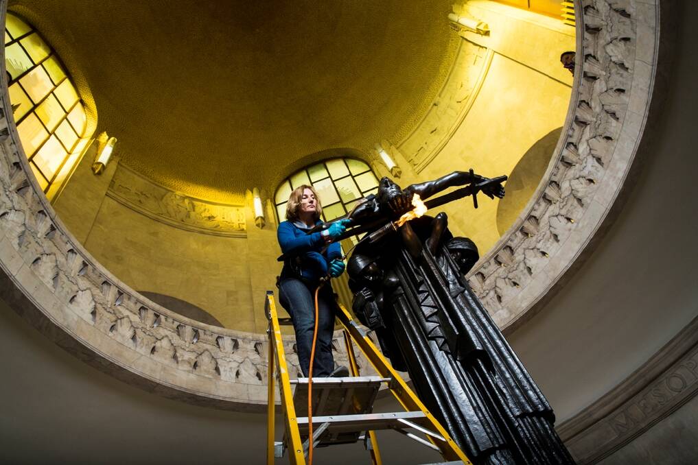LASTING LEGACY - Art conservator Anne Cummins working on at the Anzac Memorial in Hyde Park. Photo: Nic Walker.