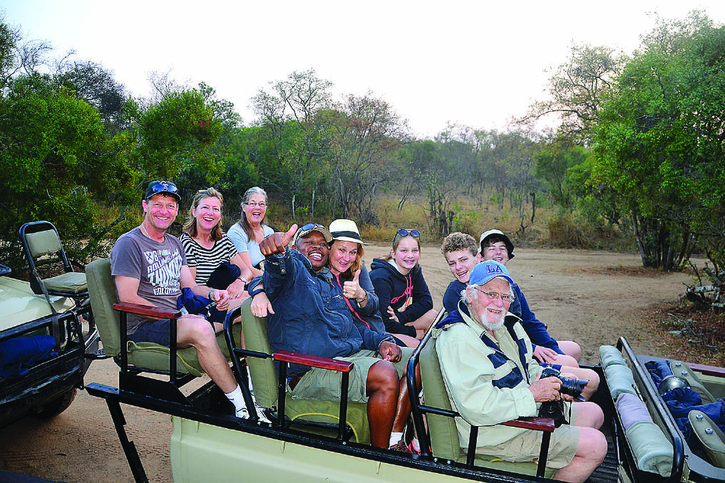 CAMERAS AT THE READY –   The O’Brien  family and friends on safari. The writer is in the front seat with his grandson Trent beside him.