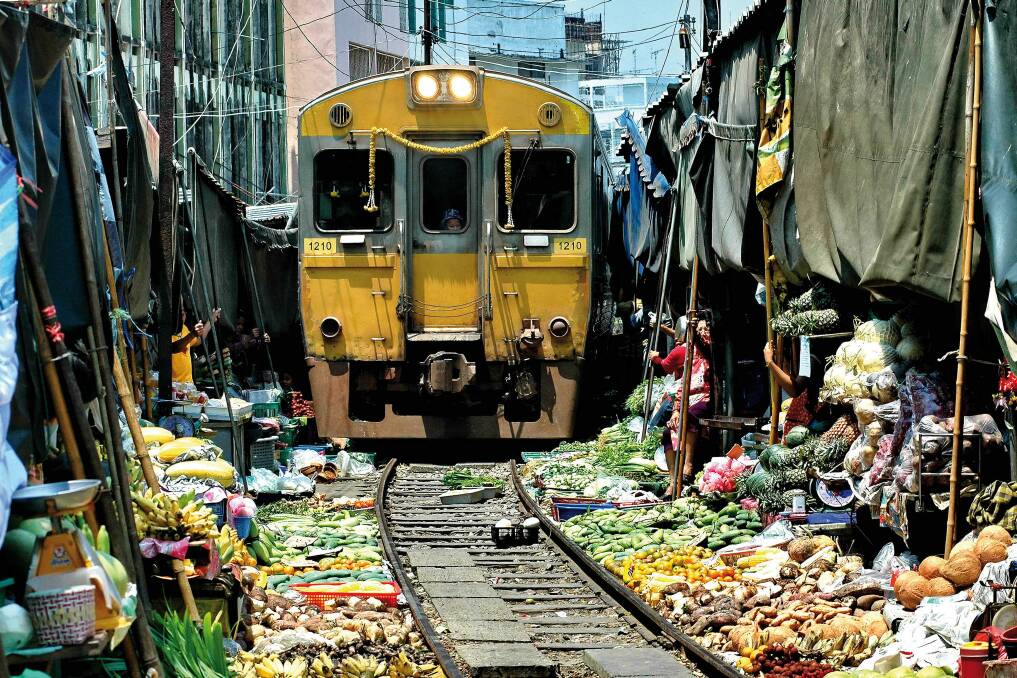 Vendors at Thailand's Maeklong Railway Market have to move their wares to make way for trains. Photo: Tourism Authority of Thailand.
