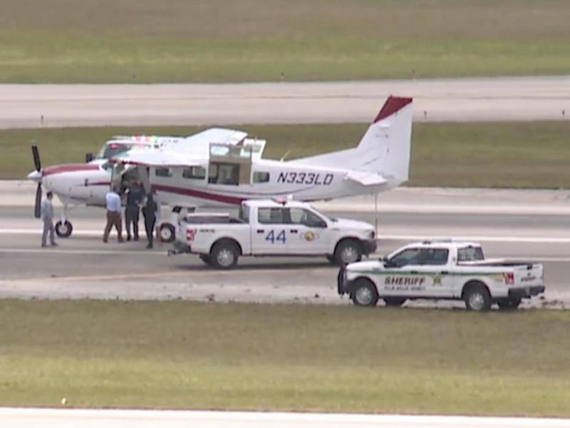 The passenger was able to land the Cessna plane safely at Palm Beach International Airport.