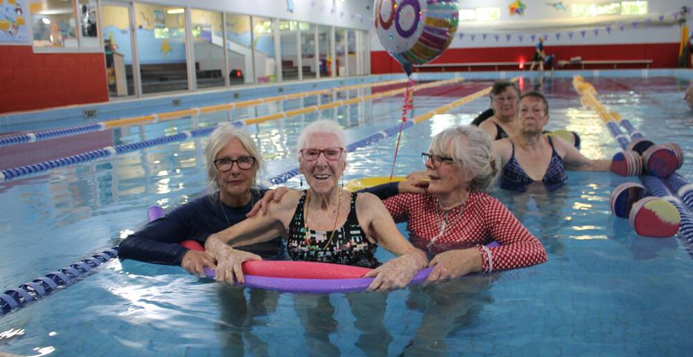IN HER ELEMENT – Margaret Gardiner enjoys a “pool party” to celebrate her 100th birthday with her daughters Kristine Gardiner (left) and Joan Tuza.