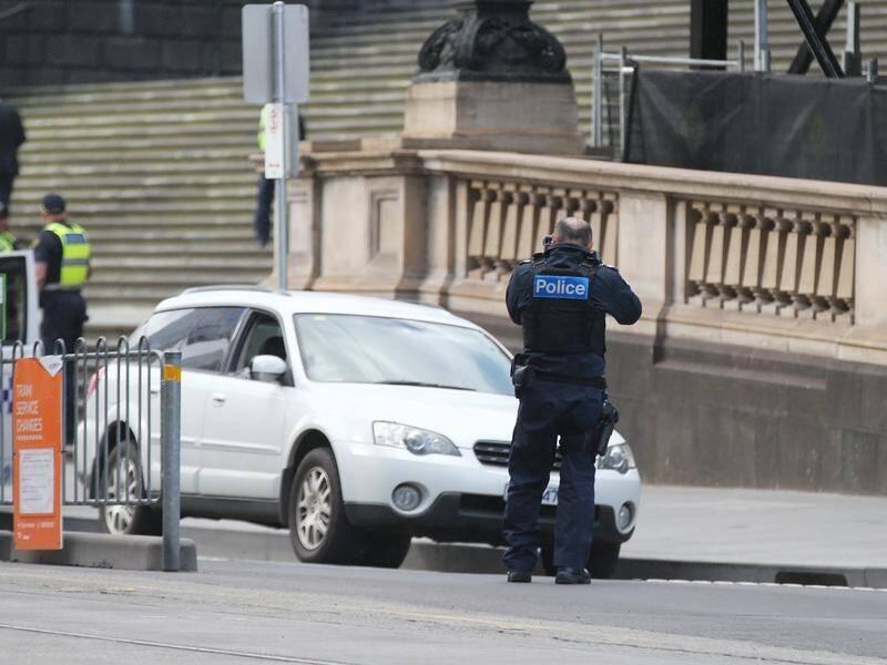 Police swarmed the area outside Victorian parliament after a man in a car threatened to self-harm.