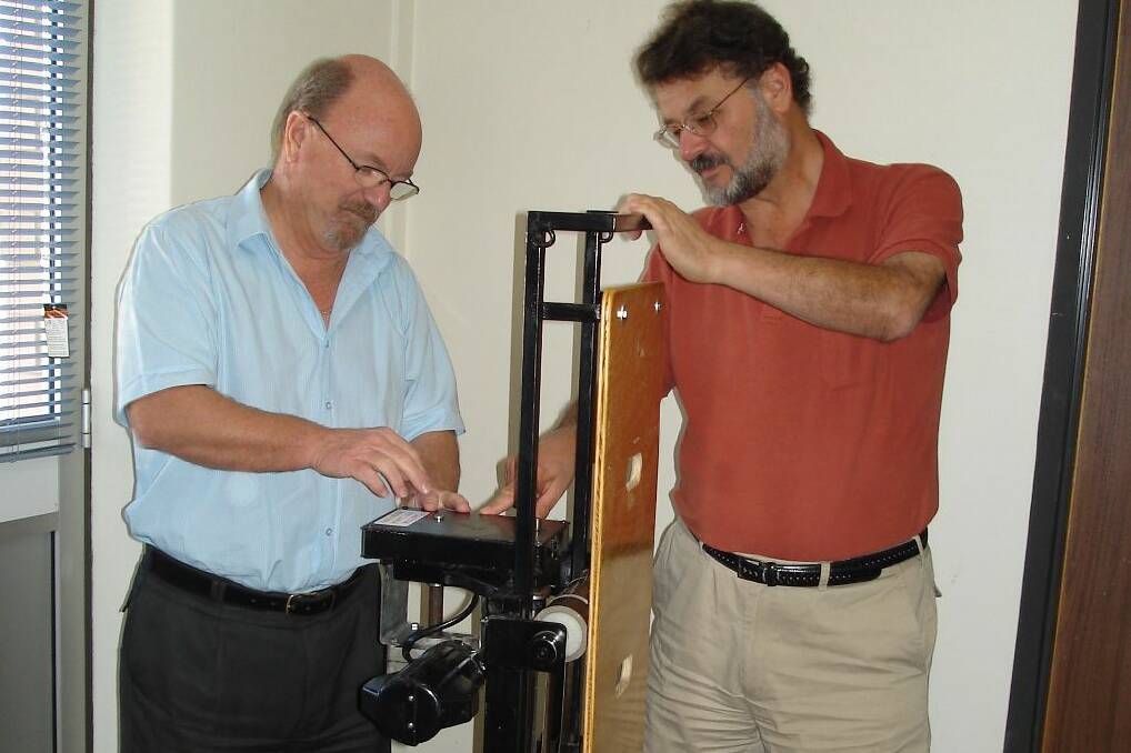 YES, CAN DO – Volunteers Richard Jackson and Travis James work on a chair device for someone who’s had a stroke.